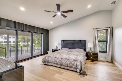 a bedroom with a bed and a ceiling fan at Pet Friendly! Canal-Front Apollo Beach Gem w/ Pool in Apollo Beach