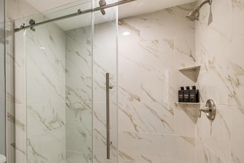 a shower with a glass door in a bathroom at Pet Friendly! Canal-Front Apollo Beach Gem w/ Pool in Apollo Beach