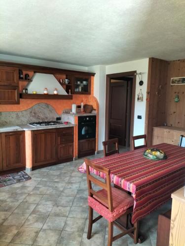 a kitchen with a table and a stove top oven at La Betulla in Oyace