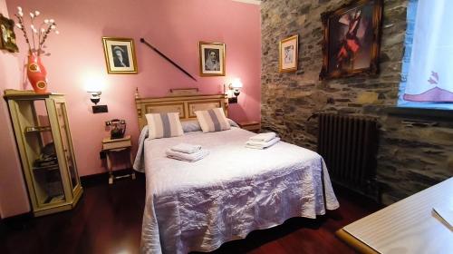 a bedroom with a bed with towels on it at Casona El Gurugu in Luarca