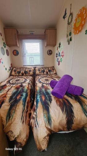 a bedroom with a large bed with feathers on it at Meadows nook in Clitheroe