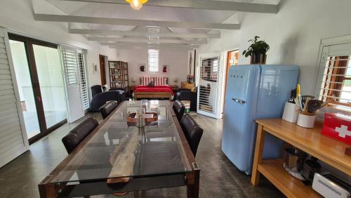 a living room with a table and a blue refrigerator at 40 on Longmarket in Stanford