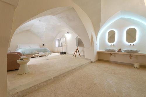 a bedroom with a bed and a sink in a room at Palazzo Galluccio in Galatina