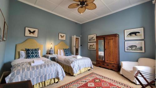 a bedroom with two beds and a ceiling fan at Stanford Villa in Stanford