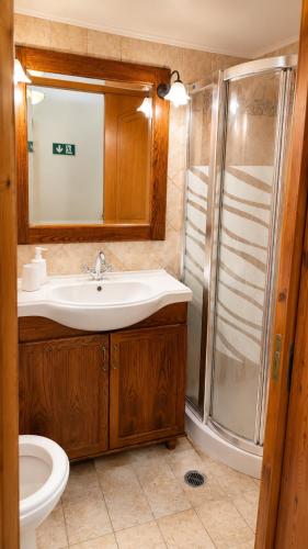 a bathroom with a sink and a shower at Pyrgos Traditional House in Pyrgi