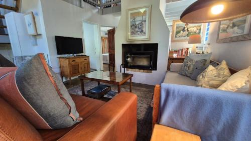 a living room with two couches and a tv at Lavender’s Blue in Stanford