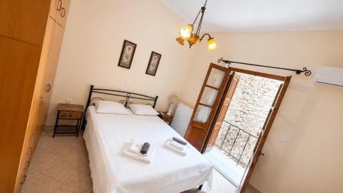 a bedroom with a bed and a window at Pyrgos Traditional House in Pyrgi