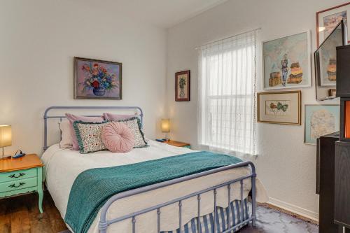 a bedroom with a bed with pink pillows and a window at < 1 Mi to Georgetown Square & SU! Extended Base in Georgetown