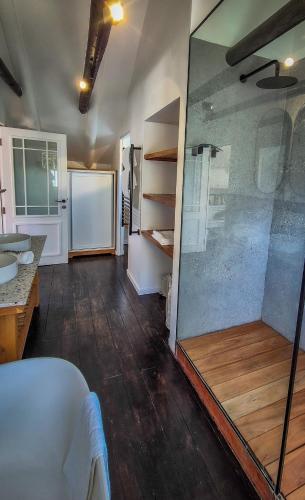 a bathroom with a glass shower and a sink at Riverside Cottage in Stanford