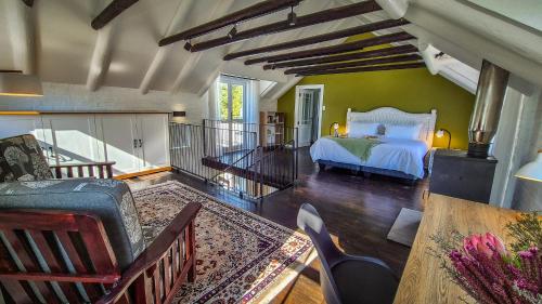 a bedroom with a bed and a green wall at Riverside Cottage in Stanford