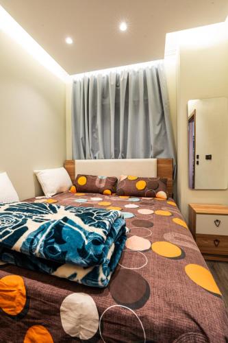a bedroom with a bed with a blanket on it at Cozy Studio Apartment in Sheikh Zayed in Sheikh Zayed