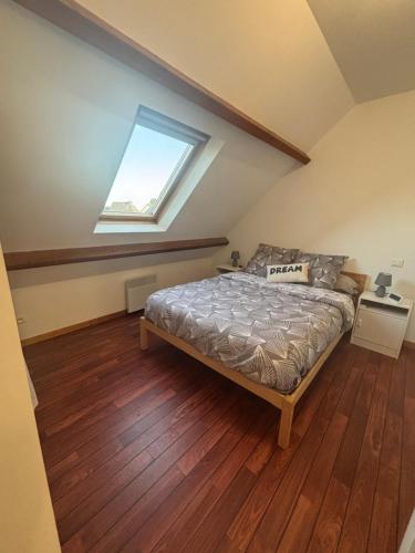 a bedroom with a bed and a window at Maison près de la mer in Yffiniac