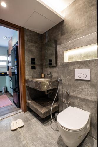 a bathroom with a sink and a toilet and a tub at Cozy Studio Apartment in Sheikh Zayed in Sheikh Zayed
