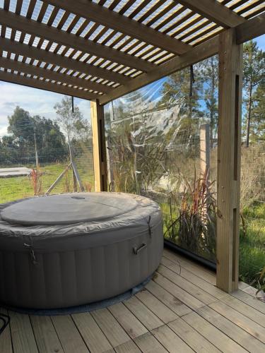 a hot tub sitting under a pergola on a deck at MiRe- Alojamiento con jacuzzi in Maldonado