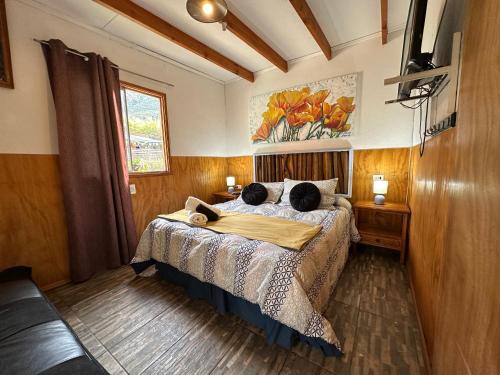a bedroom with a bed with two pillows on it at Oceana Suites Refugio de Maipo in San José de Maipo