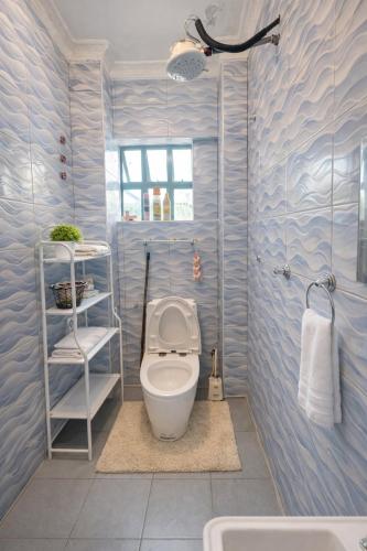 a bathroom with a toilet and a sink at The Legend Place in Eldoret