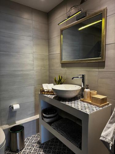 a bathroom with a sink and a mirror at ΑtoZ studio in Hydra in Hydra