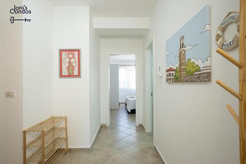 a hallway with white walls and a stair case at Joni's Twin Condos (Pool&Pine View) in Golem