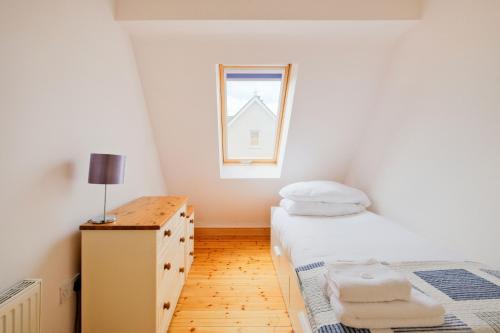 a small bedroom with a bed and a window at Beautiful 3 Bedroom House in Ennistymon