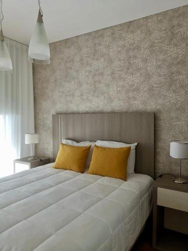a bedroom with a large bed with yellow pillows at Dessau VI in San Luis