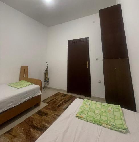 a room with a bed and a door in a room at Tresnjin hlad in Limljani