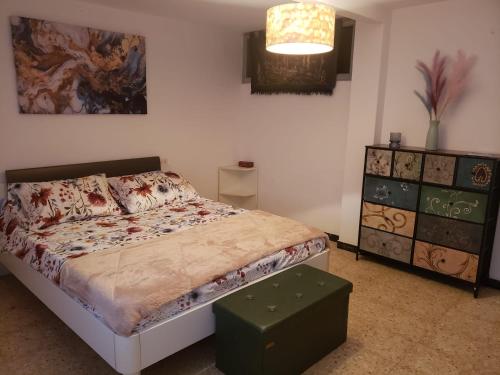 a bedroom with a bed and a dresser at Sálvora, Illas da Pousa in Ribeira