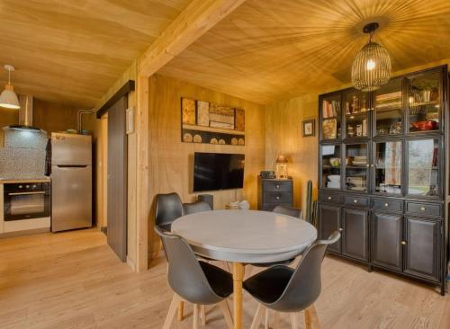a dining room with a table and chairs at Studio bois Le Colibri à Chambley in Hagéville
