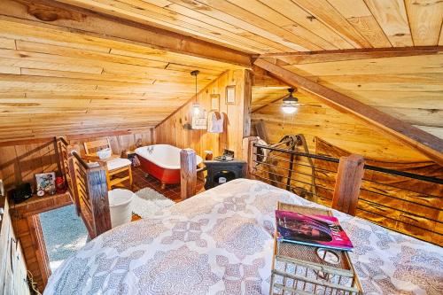 a bedroom with a bed in a wooden cabin at Nolichuckey Bluffs Bed & Breakfast Cabins in Greeneville
