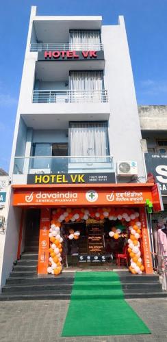 a hotel building with a green carpet in front of it at Hotel VK in Beās