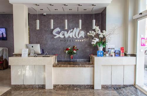 a lobby of a hotel with a reception desk at Hotel Sevilla in Ronda