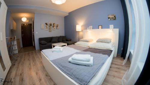 シュチェチンにあるApartamenty Sedinum - Bryzaのベッドルーム1室(ベッド1台、白いタオル2枚付)