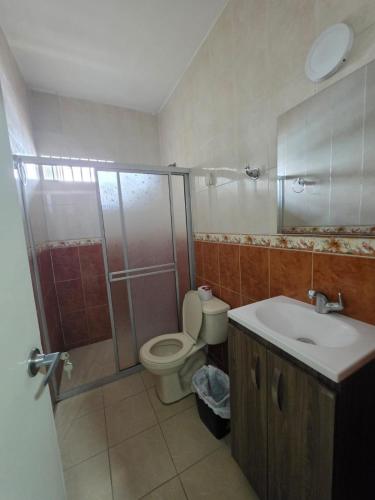 a bathroom with a toilet and a shower and a sink at EDIFICIO BENHUr in Cúcuta
