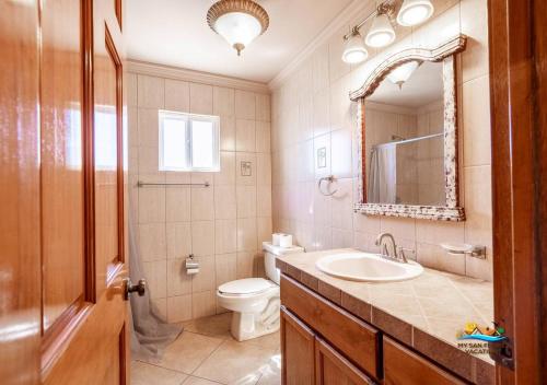 a bathroom with a sink and a toilet and a mirror at Jerry in San Felipe