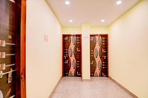 a room with two doors with guitars on the wall at Hotel O New Star Guest House in Behāla