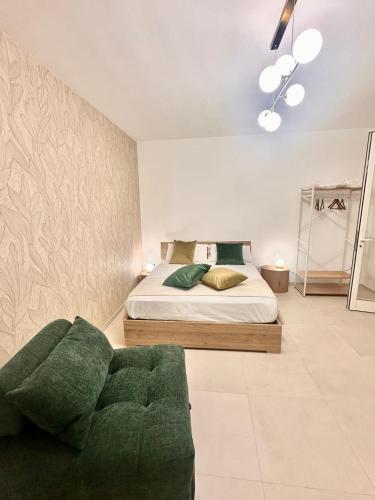a bedroom with a bed and a couch at A casa di Cetta in Melendugno