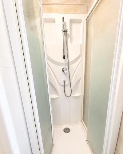 a shower stall in a bathroom with a shower at Private Room Pré-Saint-Gervais in Le Pré-Saint-Gervais