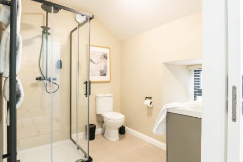 a bathroom with a shower and a toilet at Westport Selfcatering Suites in Westport