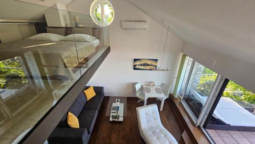 a tiny house with a large window and a bed at Apartmán Pálava 1 s terasou a výhledem na jezero in Pavlov
