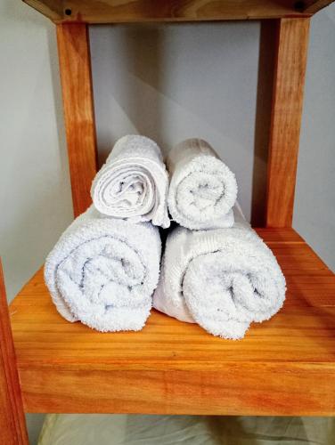 a pile of towels sitting on a wooden shelf at Hogar en el corazón de Tilcara in Tilcara