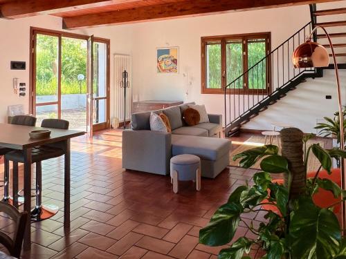 a living room with a couch and a table at Dolce Collina, Sunset Terrace & Vineyard Views in Dozza