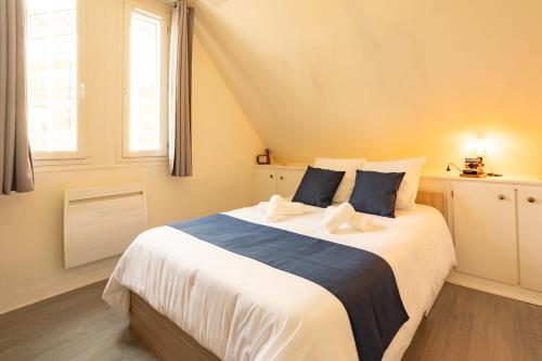 a bedroom with a large white bed with a window at Duplex hyper centre tout équipé - Arrivée autonome in Troyes