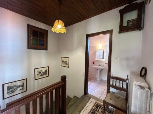 a hallway with a staircase leading to a bathroom at Little Graceland in Afissos