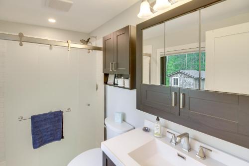 a bathroom with a sink and a mirror at Lakefront Northwoods Cabin w/ Shared Dock & Views! in Tower