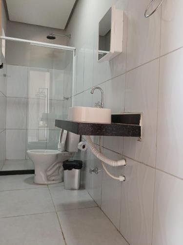 a bathroom with a sink and a toilet at Pousada Ômega in Caxias das Aldeias Altas