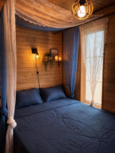 a bedroom with a bed in a room at Nia&Mari in Telavi