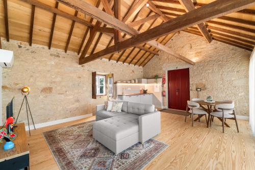 a living room with a couch and a table at RioVerde Agroturismo in Barcelos