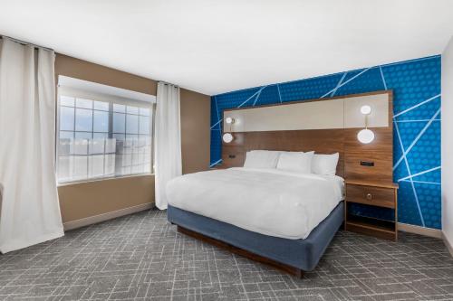 a hotel room with a bed and a large window at Comfort Inn & Suites Ogallala in Ogallala