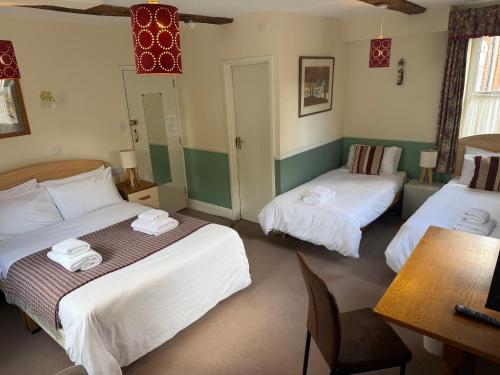 a hotel room with two beds and a table and a table at Yesterday's Guest House in Newtown