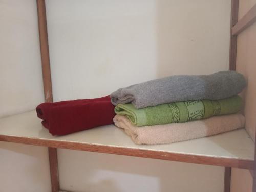 a shelf with towels sitting on top of it at Casa Verde in Quillabamba
