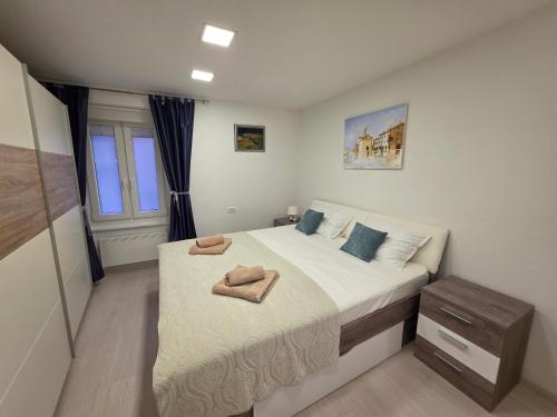 a bedroom with a large bed with towels on it at Breece Hideaway in Piran